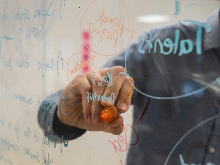 A man drawing on transparent blackboard