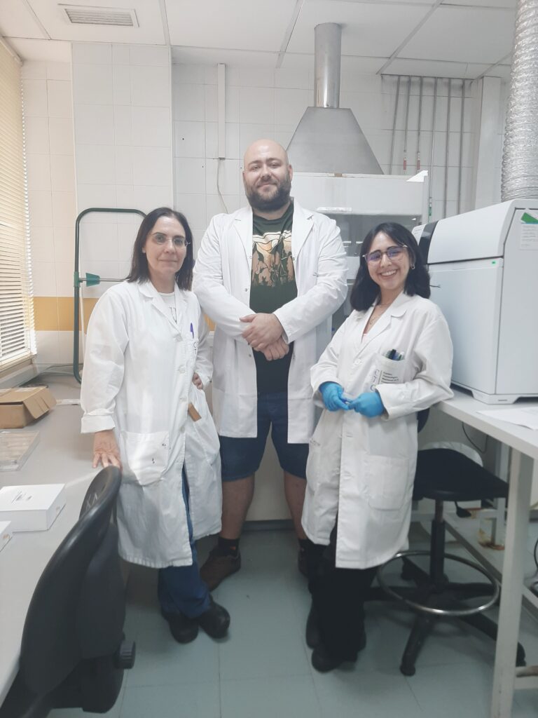 Michał Szopiński in a heavy metals analysis lab with 2 other scientists